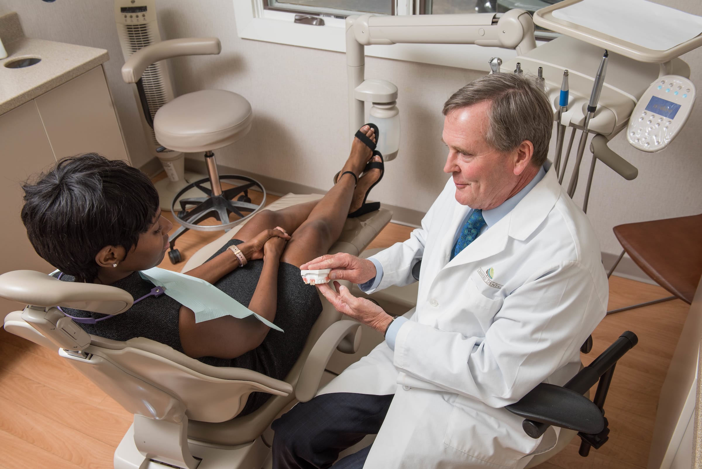 Dr Bill Cranford discussing dentures with a patient