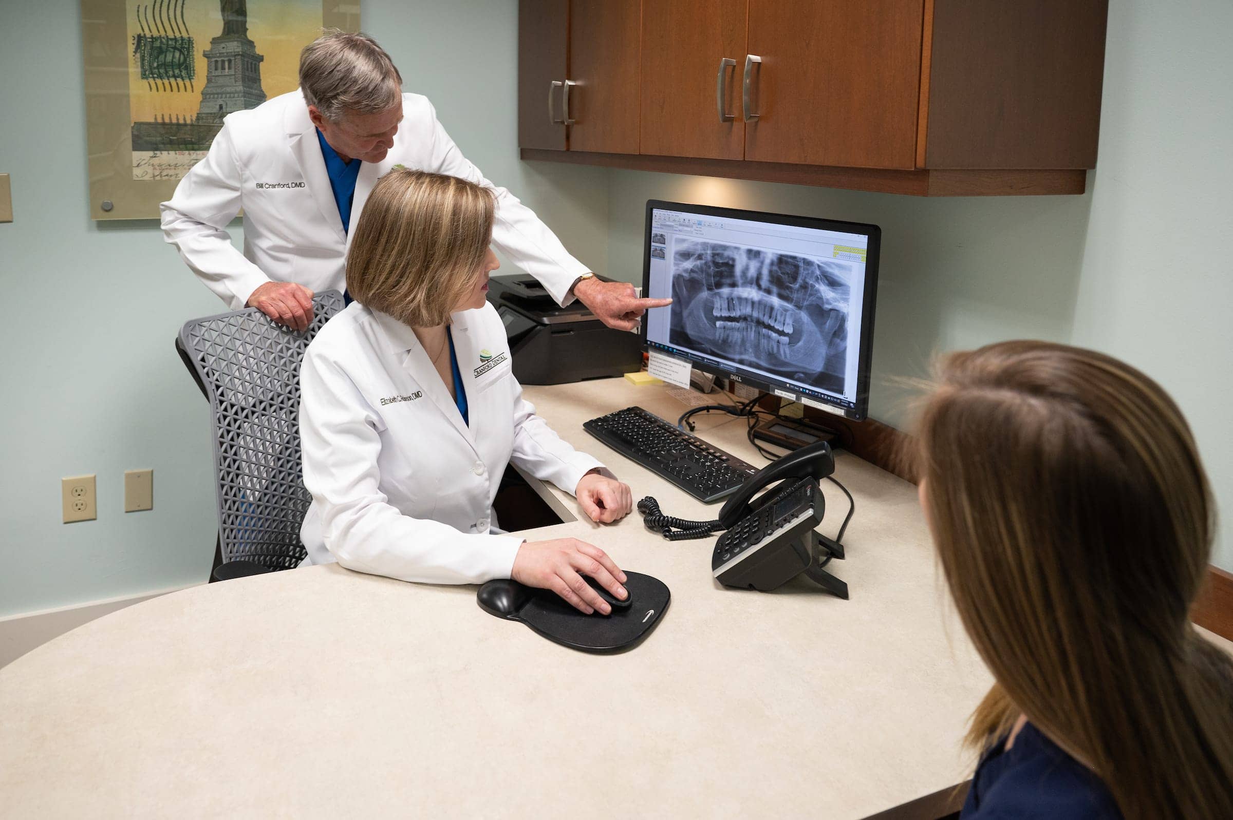 Drs Cranford and Robinson discussing root canals with assistant at Cranford Dental, Rock Hill SC
