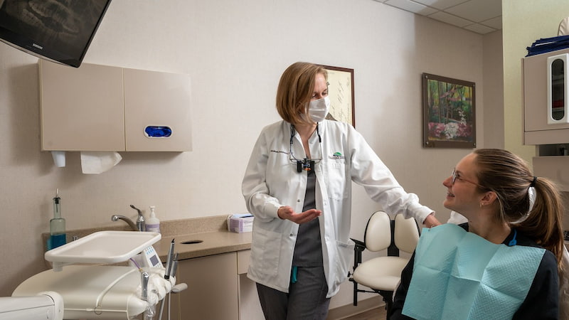 Dr. Robinson explains Sure Smile aligners to young female patient