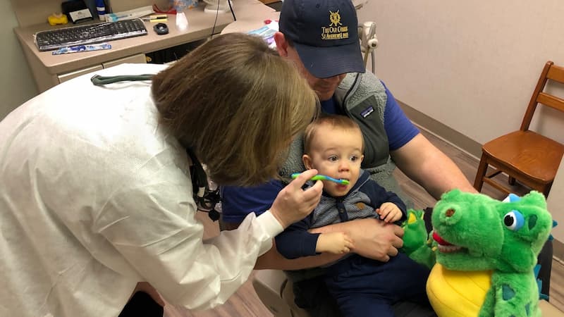 1 year old both getting teeth checked with dad