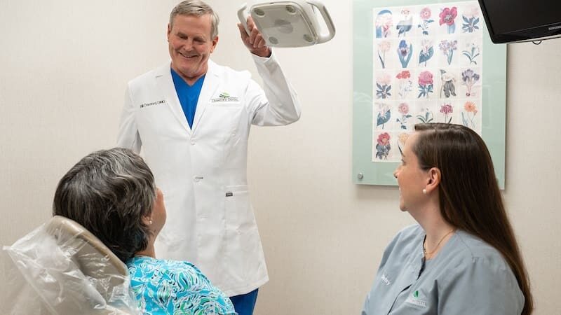 Dr. Cranford and hygienist talking to senior lady patient